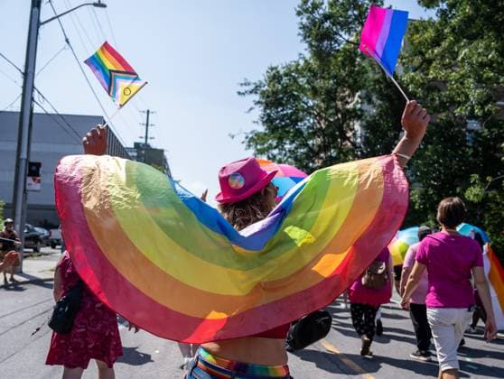 August 25, 2024, Ottawa, On, Canada: A person waves a pride flag and bisexual pride flag while marching during the Capital Pride Parade in Ottawa, on Sunday, August 25, 2024. Ottawa Canada  - ZUMAc35_ 20240825_zaf_c35_032 Copyright: xChrisxTanouyex