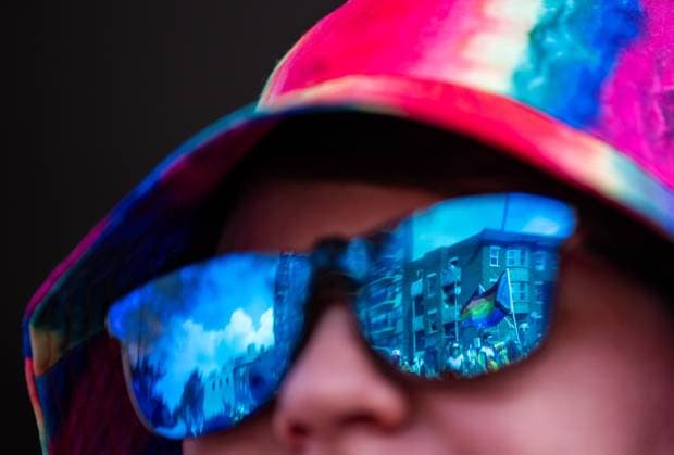 August 25, 2024, Ottawa, On, Canada: The pride flag is show in the reflection of a spectators sunglasses during the Capital Pride Parade in Ottawa, on Sunday, August 25, 2024. Ottawa Canada  - ZUMAc35_ 20240825_zaf_c35_035 Copyright: xChrisxTanouyex