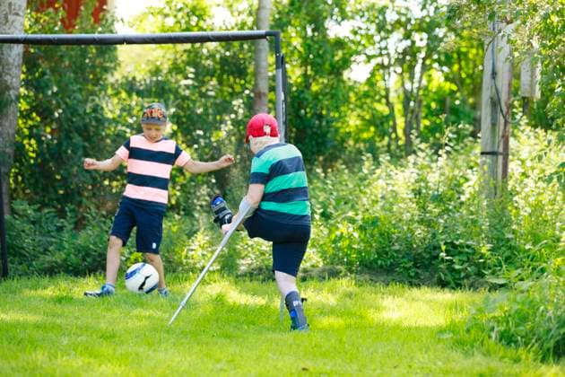 Boy playing football in garden , model released Copyright: xJohnerxImagesx , johner2491937.jpg 