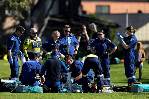 SYDNEY SOCCER DEATH, Paramedics try to resuscitate a man after he collapsed during the Granville Football Association Grand Final Day at Binalong Park, Toongabbie, NSW, Saturday, August 31, 2024. A man has died during a local soccer grand final, leading to the cancellation of other games as the community mourns. ( NO ARCHIVING, EDITORIAL USE ONLY, NO USE IN BOOKS WITHOUT CONSENT SYDNEY NEW SOUTH WALES AUSTRALIA Sydney  Copyright: xSTEVENxMARKHAMx 20240831123334839982