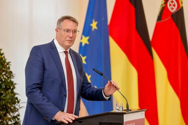 Rhineland-Palatinate Minister President Alexander Schweitzer at the lectern in front of flags in the State Chancellery of Rhineland-Palatinate Speech on the occasion of the awarding of professional titles of the state 03 09 24