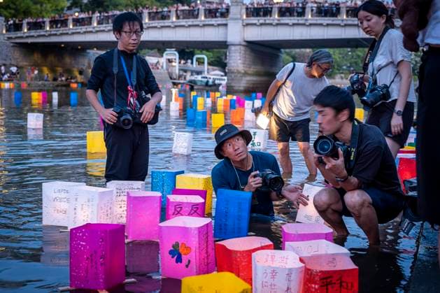 Press at work, in front of Atomic Bomb Dome with floating lamps on Motoyasu-gawa River during Peace Memorial Ceremony every August 6 in Hiroshima, Japan Copyright: xLucasxVallecillosx xVWPicsx LVM.Hi.Jp.Ag_DSF4847