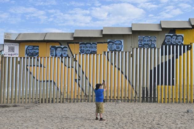 September 6, 2024, Tijuana, Baja California, Mexico: A man takes pictures with his cell phone of a new interactive mural of deported veterans at the Playas de Tijuana beach border wall, The Deported Veterans Diaspora on the Tijuana, Mexico side of the US-Mexico Border on Friday, September 06, 2024. The work, created by Lizbeth De La Cruz Santana, an assistant professor in the department of Black and Latino Studies at Baruch College in New York City, commemorates 16 war veterans who, after having served in the United States Army, were expelled from the country. The mural depicts the stories of veterans from different countries, such as Mexico, Guatemala, Haiti, the Dominican Republic and Jamaica, among others, who, after having fought on - ZUMAm180 20240906_zip_m180_002 Copyright: xCarlosxA.xMorenox