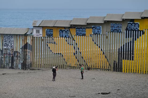 September 6, 2024, Tijuana, Baja California, Mexico: Two tourists take a selfie while posing near a new interactive mural of deported veterans at the Playas de Tijuana beach border wall, The Deported Veterans Diaspora on the Tijuana, Mexico side of the US-Mexico Border on Friday, September 06, 2024. The work, created by Lizbeth De La Cruz Santana, an assistant professor in the department of Black and Latino Studies at Baruch College in New York City, commemorates 16 war veterans who, after having served in the United States Army, were expelled from the country. The mural depicts the stories of veterans from different countries, such as Mexico, Guatemala, Haiti, the Dominican Republic and Jamaica, among others, who, after having fought o - ZUMAm180 20240906_zip_m180_003 Copyright: xCarlosxA.xMorenox