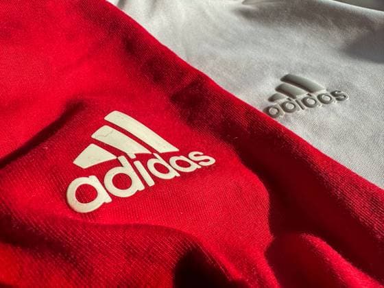 Adidas, logo, sportswear, red and white, brand logo, sports fashion, athleisure, design, textiles, sports brand, fashion, casual wear, workout wear, sporting goods manufacturer, style, lifestyle, brand identity, sports industry, fitness wear, athletics, sports trends, colors red and white, material, texture, fabric Copyright: xJOERANxSTEINSIEKx