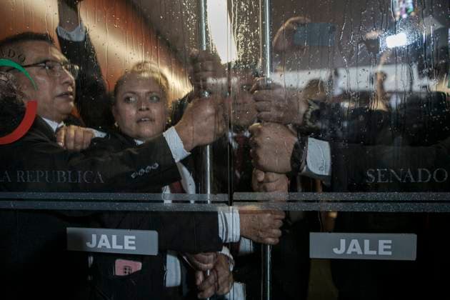 September 10, 2024, Mexico, Mexico: Guards of the Mexican Senate chamber try to keep the doors of the session chamber closed in the face of attacks by protesters who have broken into the main building. The protests that are shaking Mexico are a direct response to the judicial reform proposal presented by President AndrÃ s Manuel Lopez Obrador. This reform, which seeks to modify the structure and functioning of the Judiciary, has generated a wave of criticism and mobilizations from various sectors of society. Especially from workers in the Justice system who say this Reform threatens judicial independence: Critics argue that the reform sought to subject the Judicial Branch to the Executive, weakening the separation of powers and putting the - ZUMAs197 20240910_aaa_s197_452 Copyright: xIsraelxFuguemannx
