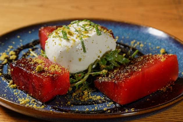 September 11, 2024, St. Petersburg, Florida, USA: Burrata and Compressed Watermelon with.arugula, herb vinaigrette, roasted pistachios, balsamic reduction, and garlic oil is pictured at Brick and Mortar on Wednesday, Sept. 11, 2024 in St. Petersburg. St. Petersburg USA - ZUMAs70_ 20240911_zan_s70_024 Copyright: xLuisxSantanax