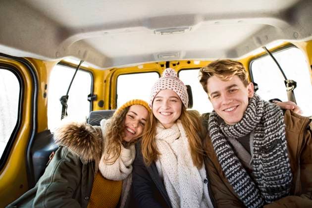 Friends going skiing at ski resort, spending the Christmas holidays together in a cabin. Driving car through a snowy landscape. Friends going skiing at ski resort, spending the Christmas holidays together in a cabin. Driving car through snowy landscape. model released