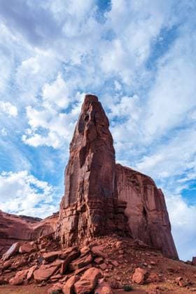Creative Highlights World Towering red sandstone spire beneath a vibrant sky in Monument Valley. Oljato-Monument Valley, Arizona, United States R_OCZQ240915-1541109-01