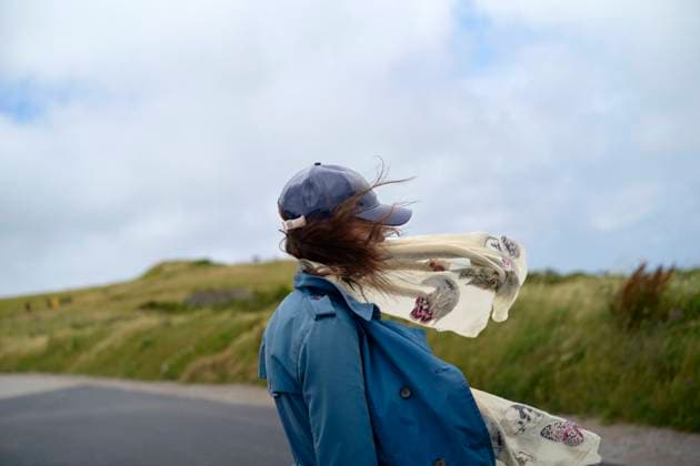 Creative Highlights Symbolfotos Woman with her back to the camera walking on a country road, with wind blowing her hair and scarf. bola03162 Copyright: xConnectxImagesx ,model released