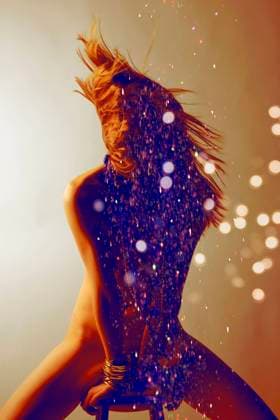 Creative Highlights Symbolfotos Silhouetted woman with dynamic hair movement surrounded by sparkling glitter and warm glowing lights. krst00405 Copyright: xConnectxImagesx ,model released