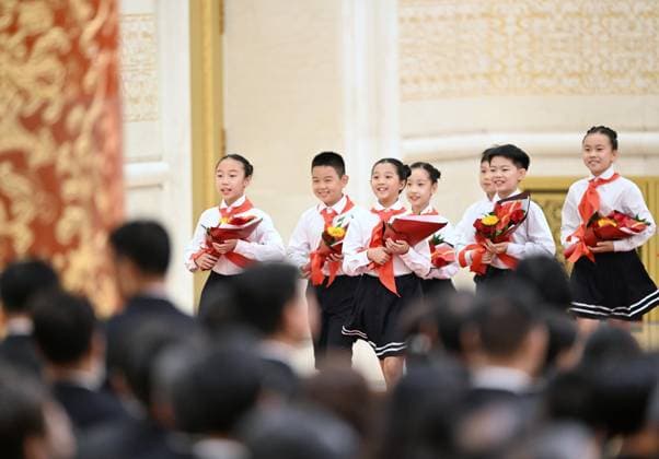 (240929) -- BEIJING, Sept. 29, 2024 -- Members of the Chinese Young Pioneers enter the venue of the presentation ceremony to present flowers to the recipients of national medals and honorary titles at the Great Hall of the People in Beijing, capital of China, Sept. 29, 2024. China held a high-profile ceremony on Sunday morning to award the highest state honors ahead of the 75th founding anniversary of the People s Republic of China. ) (FOCUS)CHINA-BEIJING-HIGHEST STATE HONORS-CEREMONY (CN) YanxYan 