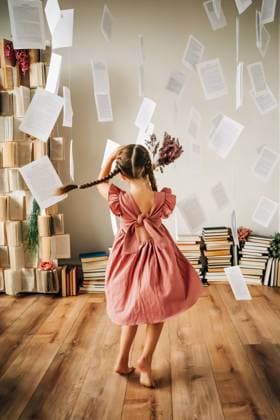 Creative Highlights Symbolfotos Girl with braids in a pink dress twirling in with floating pages North Andover, Massachusetts, United States CR_FKNH240904-1527186-01 ,model released, Symbolfoto