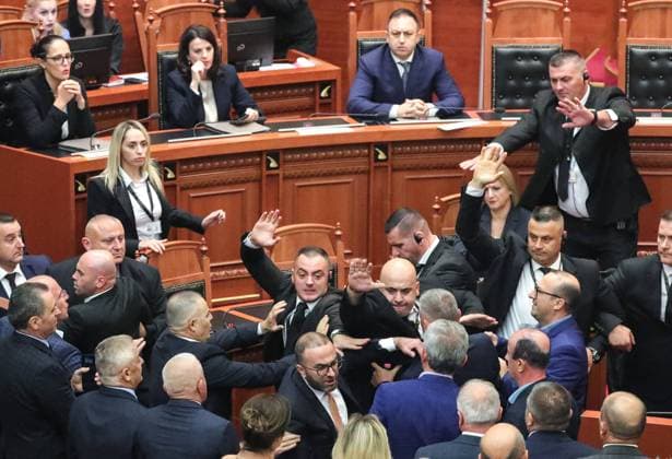 September 30, 2024, Tirana, Tirana, Albania: A Member of opposition Democratic party of Albania parliament attempts to throw an object to the speaker of the parliament as bodyguards try to stop him, on the day of members of opposition burnt their chairs outside the parliament building, to protest against the government. Tirana Albania - ZUMAb266 20240930_zip_b266_036 Copyright: xArmandoxBabanix