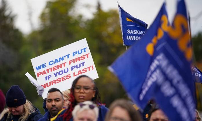 October 3, 2024, Regina, Sk, Canada: People hold signs and flags during a rally organized by Saskatchewan Union of Nurses in Regina, on Thursday, October 3, 2024. Regina Canada  - ZUMAc35_ 20241003_zaf_c35_099 Copyright: xHeywoodxYux