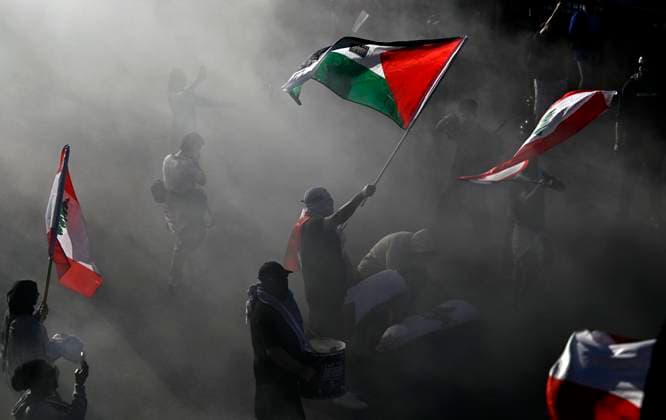 October 5, 2024, Ottawa, On, CAN: The flags of Palestine and Lebanon are waved by Pro-Palestine demonstrators among smoke from flares, during a rally in Ottawa, on Saturday, Oct. 5, 2024. Ottawa CAN  - ZUMAc35_ 20241005_zaf_c35_126 Copyright: xJustinxTangx
