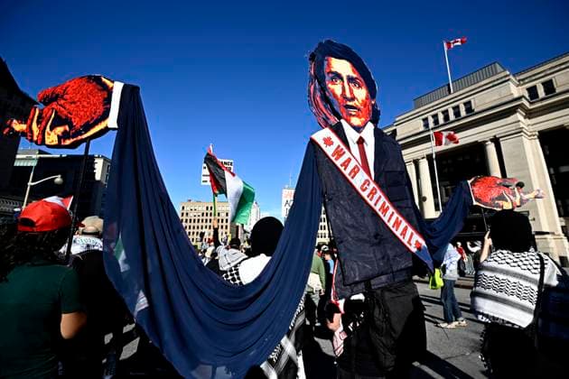 October 5, 2024, Ottawa, On, CAN: An effigy of Prime Minister Justin Trudeau is carried by pro-Palestine demonstrators as they march past the Senate of Canada Building in Ottawa, on Saturday, Oct. 5, 2024. Ottawa CAN  - ZUMAc35_ 20241005_zaf_c35_127 Copyright: xJustinxTangx