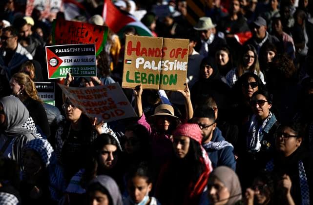 October 5, 2024, Ottawa, On, CAN: Demonstrators hold up a sign in support of Palestine and Lebanon during a march in downtown Ottawa, on Saturday, Oct. 5, 2024. Ottawa CAN  - ZUMAc35_ 20241005_zaf_c35_132 Copyright: xJustinxTangx