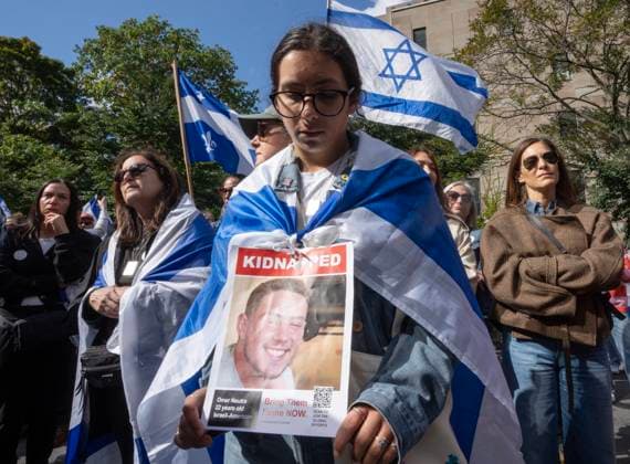 October 7, 2024, Montreal, Pq, Canada: A woman holds a photo of a hostage during a pro-Israel vigil on the anniversary of a Hamas attack on Israel that triggered the ongoing war in Gaza in front of McGill University, in Montreal, Monday, Oct. 7, 2024. Montreal Canada  - ZUMAc35_ 20241007_zaf_c35_016 Copyright: xRyanxRemiorzx