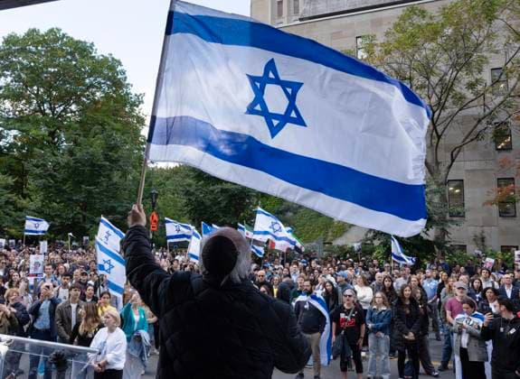 October 7, 2024, Montreal, Pq, Canada: A speaker waves an Israeli flag during a pro-Israel vigil on the anniversary of a Hamas attack on Israel that triggered the ongoing war in Gaza in front of McGill University, in Montreal, Monday, Oct. 7, 2024. Montreal Canada  - ZUMAc35_ 20241007_zaf_c35_019 Copyright: xRyanxRemiorzx