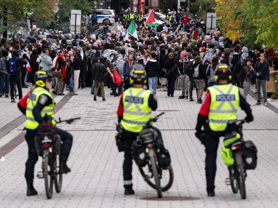 October 7, 2024, Montreal, Pq, CANADA: Police watch as attendees march near McGill University campus during a pro-Palestinian demonstration on the anniversary of a Hamas attack on Israel that triggered the ongoing war in Gaza, in Montreal, Monday, Oct. 7, 2024. Montreal CANADA  - ZUMAc35_ 20241007_zaf_c35_083 Copyright: xChristinnexMuschix