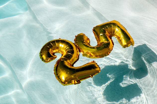 This image showcases shiny golden inflatable balloons shaped as the number 30 floating on the tranquil surface of a sparkling clear blue swimming pool. Model Released SergioVictorVega_ID24228_702418_025 Copyright: xSergioxVictorxVegax