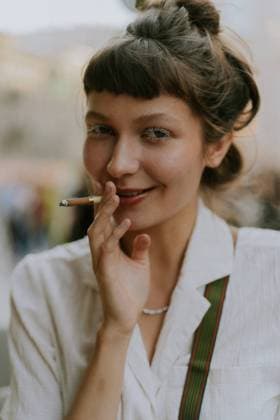 Creative Highlights Symbolfotos Young stylish woman smokes a cigarette on the street. Saint Petersburg, Saint Petersburg, Russia CR_YUKI241007A-1554749-01 ,model released, Symbolfoto