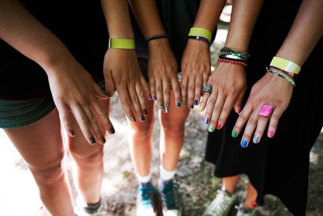 Hands, manicure and woman friends at music festival together, in a circle outdoor closeup from above. Party, concert or show with a group of people at a carnival for performance or entertainment. model released property released Copyright: xwww.PeopleImages.comxLicensexRestrictionsxApplyx