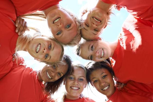 Team, women and happy with sport huddle for support, celebration or solidarity with blue sky and low angle. Collaboration, athlete and people with smile in circle for fitness, exercise or competition. model released property released Copyright: xPeopleImages.comx-x 52f333056d40ex