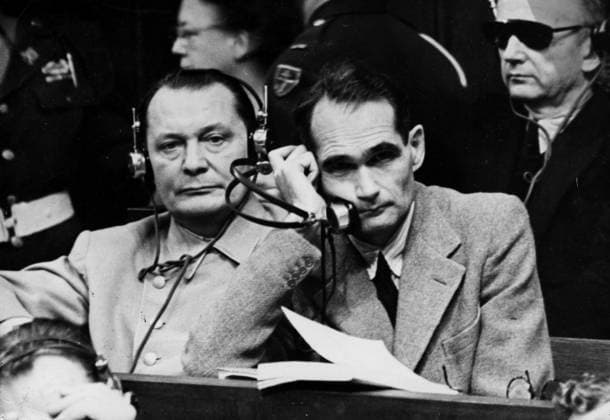 Orig. caption... ILS SERONT PENDUS: N.P.M. de gauche a droite: GOERING, HESS et RIBBENTROP, dans le box des accusus. Goering and Ribbentrop, coupables de 4 chiefs d accusation, seront pendus. Quant a Hess, contre qui on n a retenu que deux chiefs d accusation, il aura la vie sauve: il est condamnÃ a la prison a perpetuitÃ . Note Headphones persons: HERMANN GÖRING; RUDOLF HESS sites: NÜRNBERG; GERMANY sp_sw x5600x *** Orig caption THEY WILL BE HANGED N P M from left to right GOERING, HESS and RIBBENTROP, in the dock Goering and Ribbentrop, guilty of 4 counts, will be hanged As for Hess, against whom only two counts have been brought, he will be spared his life he is sentenced to prison for life Note Headphones persons HERMANN GÖRING  Copyright: xXxXxXx THE NUREMBERG PROCESS