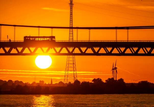 Traffic on the Rhine bridge Emmerich, federal road B220, evening light, with 803 m the longest suspension bridge in Germany shortly before the Dutch border, Rhine kilometer 853.2 it is the northernmost German Rhine bridge, NRW, Germany Rhine bridge Emmerich