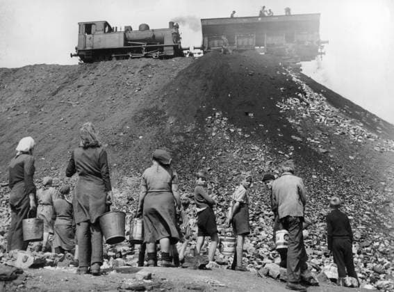 Orig. caption... COAL SCAVENGERS OF THE RUHR. Although the population of the Ruhr area should have no worries whatsoever about getting coal for wintertime, women and children gather daily at factory sites in the hope of collecting pieces for the cold winter ahead. Photo shows: Woman children with their buckets hang around in the hope that coal will fall from the wagons of a Ruhr factory. Orig. caption... Although the population of the Ruhr area should have no worries whatsoever about getting coal for wintertime, they seem to have every reason to try to get something at least wherever there is a chance. Pict shows: These women try to get some of the coals which fall from the waggons of a Ruhr factory to have at least something for the first  Copyright: xx IN HUNT FOR COAL