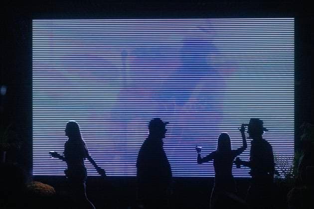 October 18, 2024, Sacramento, Ca, USA: Fans walk past TV monitors during the Golden Sky Music Festival at Discovery Park on Friday, Oct. 18, 2024 in Sacramento. Sacramento USA - ZUMAj89_ 20241018_zaf_j89_021 Copyright: xPaulxKitagakixJr.x