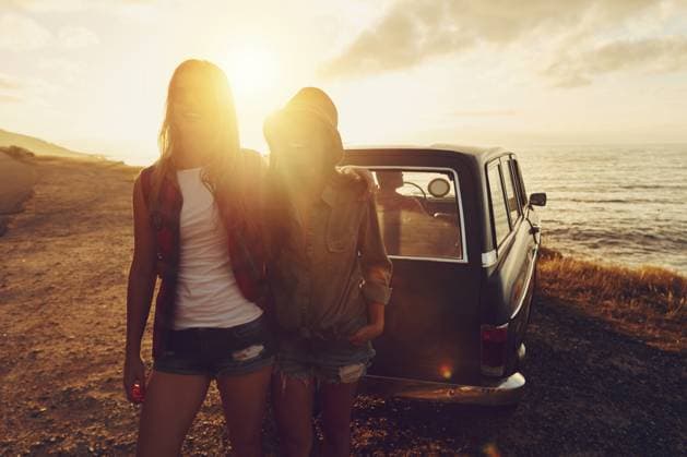 Sunset lens flare with women, car and road trip, travel with friends at beach, outdoor with nature and sea holiday. Transportation, freedom and sunshine on summer vacation, happiness with adventure. model released property released Copyright: xx