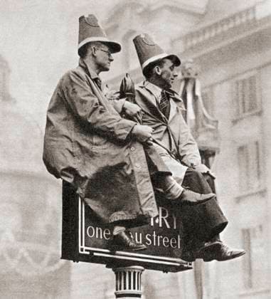 RECORD DATE NOT STATED Two men atop a traffic sign in order to get a better view of the Coronation procession of George VI and Queen Elizabeth. Two men atop a traffic sign in order to get a better view of the Coronation procession of George VI and Queen Elizabeth, London, England, 1937. From The Coronation in Pictures, published 1937. Copyright: KenxWelshx xDesignxPics 902_05_13255448HighRes
