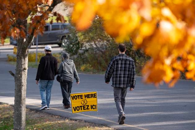 October 21, 2024, Fredericton, Nb, Canada: Voters walk past a voting sign after casting their ballot in the New Brunswick provincial election at a polling location in Fredericton, N.B. on Monday, October 21, 2024. Fredericton Canada  - ZUMAc35_ 20241021_zaf_c35_093 Copyright: xDarrenxCalabresex