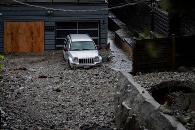October 22, 2024, North Vancouver, Bc, CANADA: A home and vehicle is seen surrounded by debris left by flooding from torrential rain from an atmospheric river weather system at Deep Cove in North Vancouver, on Tuesday, October 22, 2024. North Vancouver CANADA  - ZUMAc35_ 20241022_zaf_c35_123 Copyright: xEthanxCairnsx