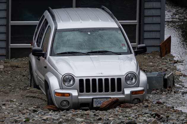 October 22, 2024, North Vancouver, Bc, CANADA: A vehicle is seen surrounded by debris left by flooding from torrential rain from an atmospheric river weather system at Deep Cove in North Vancouver, on Tuesday, October 22, 2024. North Vancouver CANADA  - ZUMAc35_ 20241022_zaf_c35_124 Copyright: xEthanxCairnsx