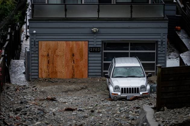 October 22, 2024, North Vancouver, Bc, CANADA: A home and vehicle are seen surrounded by debris left by flooding from torrential rain from an atmospheric river weather system at Deep Cove in North Vancouver, on Tuesday, October 22, 2024. North Vancouver CANADA  - ZUMAc35_ 20241022_zaf_c35_126 Copyright: xEthanxCairnsx