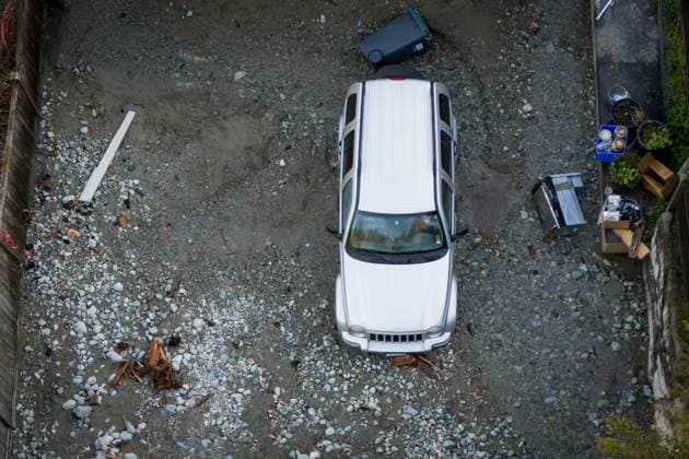 October 22, 2024, North Vancouver, Bc, CANADA: A vehicle is seen surrounded by debris left by flooding from torrential rain from an atmospheric river weather system at Deep Cove in North Vancouver, on Tuesday, October 22, 2024. North Vancouver CANADA  - ZUMAc35_ 20241022_zaf_c35_129 Copyright: xEthanxCairnsx