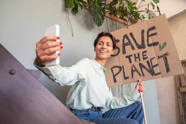 Happy activist taking selfie with environment placard model released, Symbolfoto property released, VPIF08589