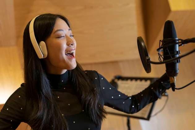 Cheerful young singer singing and recording song in studio model released, Symbolfoto property released, EAF00310