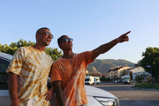 Man pointing near brother standing by car model released, Symbolfoto property released, SYEF00580