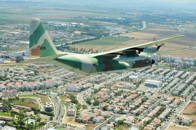 Lockhead C-130 Hercules fly above Netivot Israel NETIVOT - MAY 10 2011:Lockhead C-130 Hercules fly above Netivot, Israel.The C-130 was used in the 1976 Entebbe raid in which Israeli commando forces surprise operation at Entebbe Airport, Uganda. EDITORIAL USE ONLY Copyright: xx RafaelxBen-Arix cewitness104883