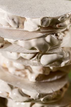 A detailed close-up view of layered traditional Christmas sweets, featuring slices of white nougat Turron de Alicante. Model Released AlexSalcedo_ID24574_712225_011 Copyright: xAlexxSalcedox RECORD DATE NOT STATED