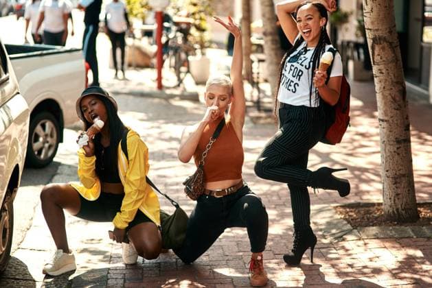 Women friends, ice cream and street in city with edgy gen z fashion, comic pose or happiness on travel. Group, young woman and students with smile, gelato or dessert on summer vacation for crazy trip. model released property released Copyright: xPeopleImages.comx-x 1997112x