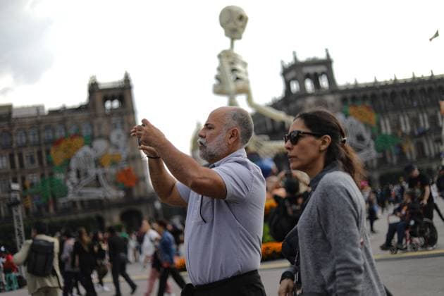Mega Ofrenda For Dia de Muertos Celebrations A person taking photos of the Mega Ofrenda featuring monumental cardboard skeletons at the main square Zocalo as part of the Mexican Dia de Muertos festivities. on October 31, 2024 in Mexico City, Mexico. (Photo by Ian Robles Eyepix Group) Copyright: xIanxRobles xEyepixxGroupx EL_31102024_134235JPEG