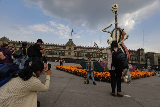 Mega Ofrenda For Dia de Muertos Celebrations Persons taking photos of the Mega Ofrenda featuring monumental cardboard skeletons at the main square Zocalo as part of the Mexican Dia de Muertos festivities. on October 31, 2024 in Mexico City, Mexico. (Photo by Ian Robles Eyepix Group) Copyright: xIanxRobles xEyepixxGroupx EL_31102024_134238JPEG