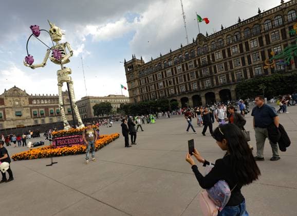 A person taking photos of the Mega Ofrenda featuring monumental cardboard skeletons at the main square Zocalo as part of the Mexican Dia de Muertos festivities. on October 31, 2024 in Mexico City, Mexico. Mexico City Mexico - ZUMAe321 20241031_zia_e321_060 Copyright: xIanxRoblesx