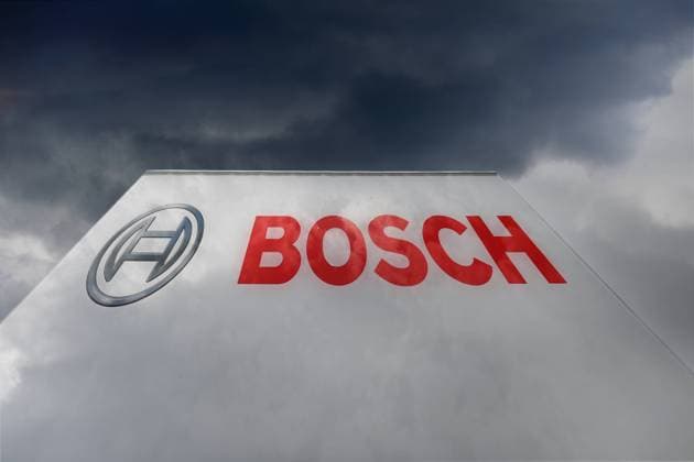 Themed picture Bosch cancels forecast and does not rule out job cuts Robert Bosch GmbH logo, company emblem in front of dark clouds duester,